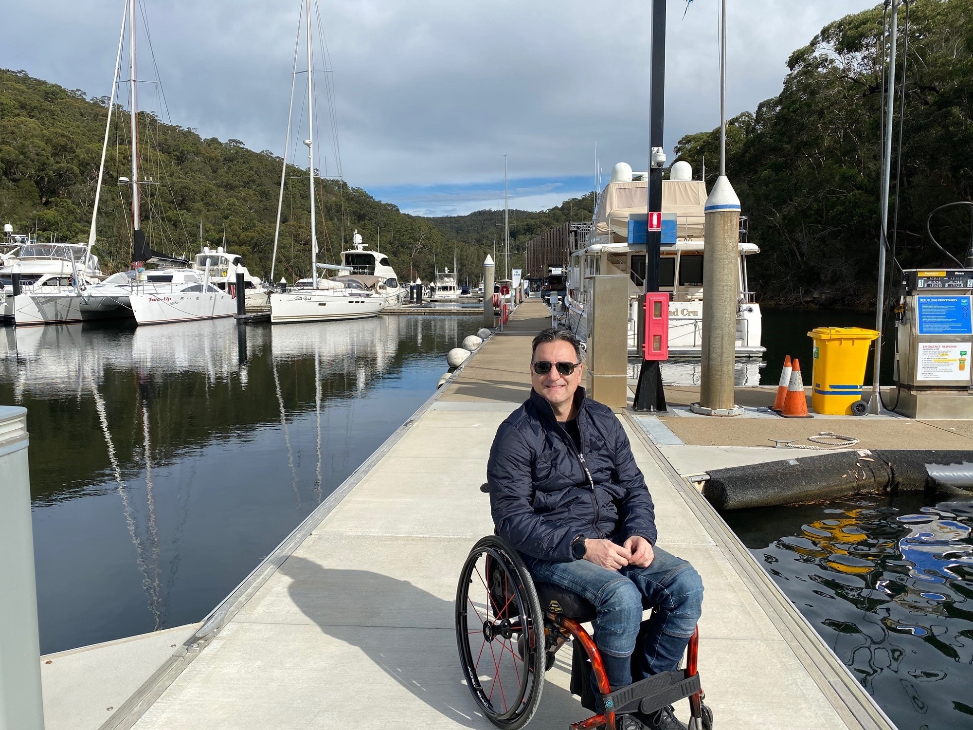 Male in wheelchair on boat dock